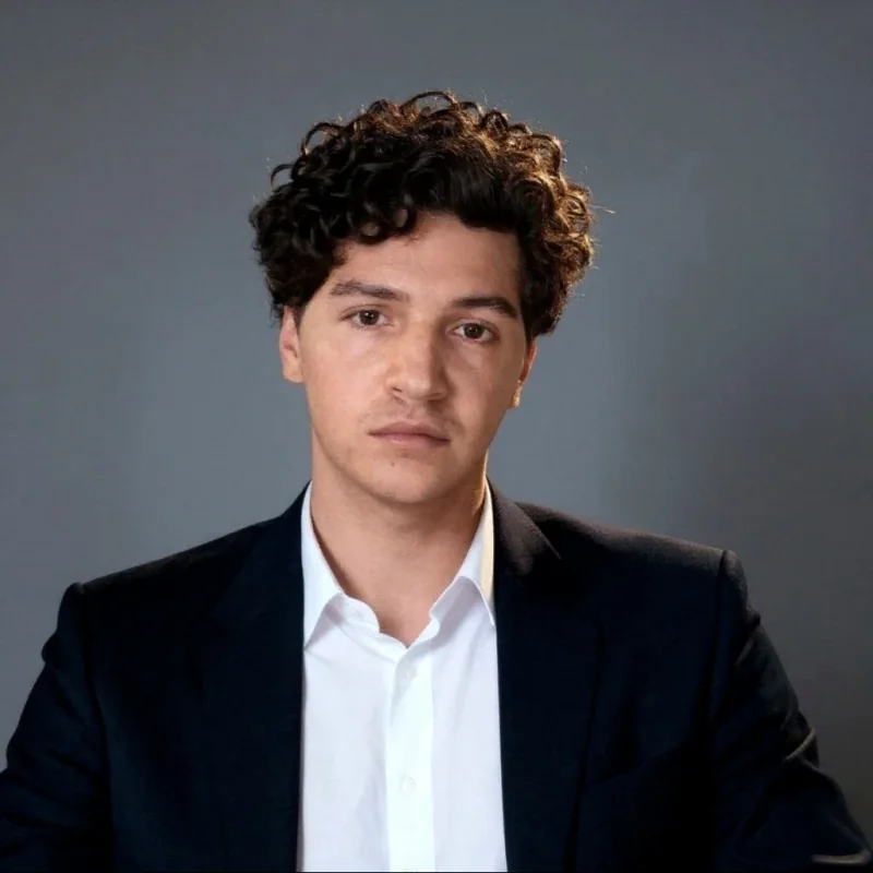 Derick Howard in a black suit jacket and white shirt